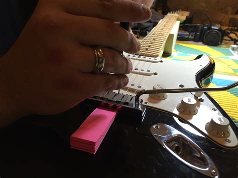 How to Lower Action on Electric Guitar: A Symphony of Strings and Screws